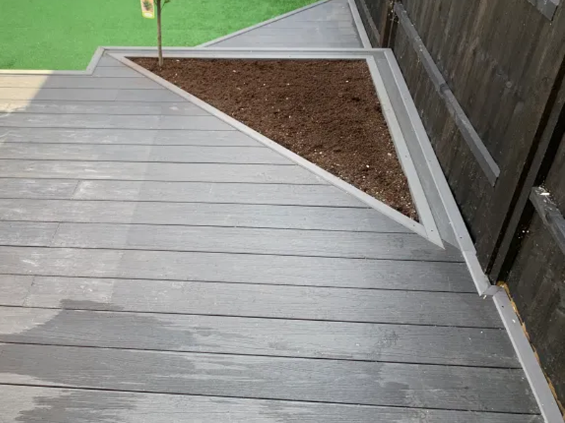 Composite decking and triangular flowerbed 