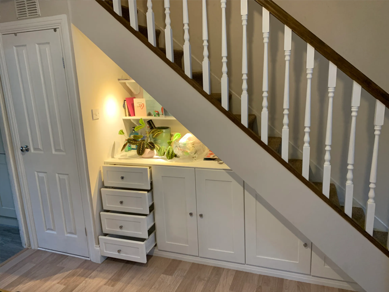 Stairway with new a new handrail, posts and spindles. Understairs fitted shelves, draws and storage cupboards with a brilliant white finish