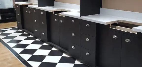 matt black finish with brilliant white work surfaces and chrome cupboard door and draw handles.