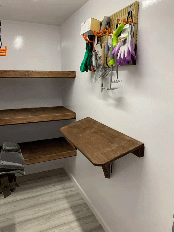 The inside of the garden room displaying the fitted and floating shelves