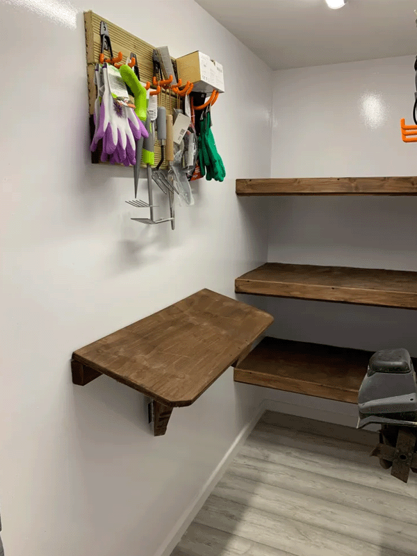 The inside of the garden room displaying the fitted and floating shelves