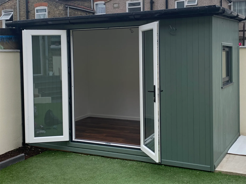Small garden office with open French doors