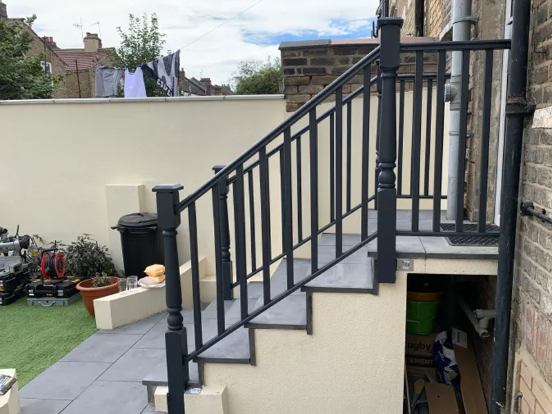 Solid oak handrail and spindles on a tiled staircase