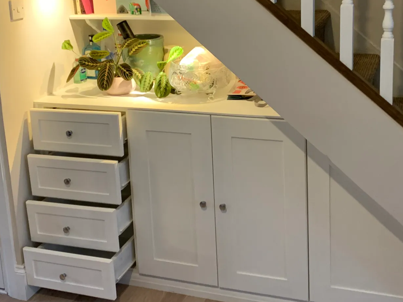 side view built in white painted MDF cupboard and drawer unit