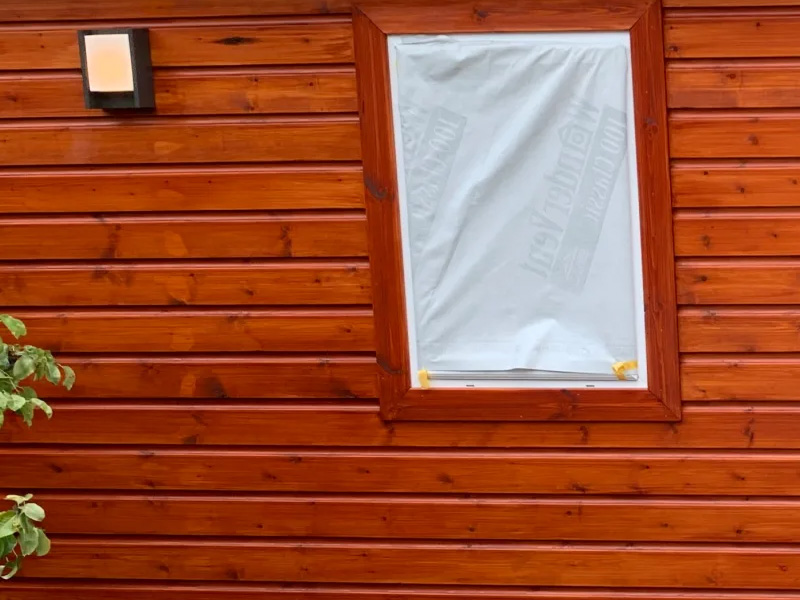Close up of treated timber cladding and exterior lighting