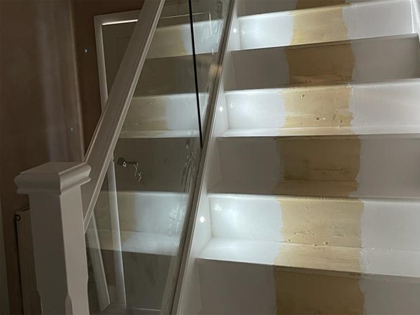 Staircase with glass balustrade and spotlights