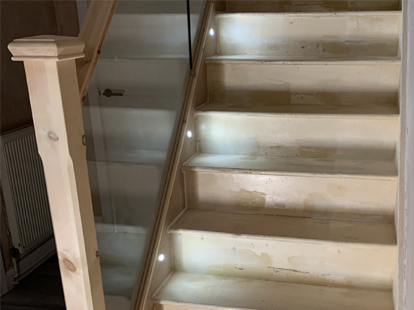 pine staircase with spotlighting and glass balustrade
